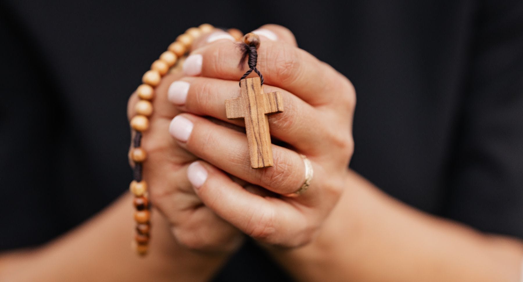 catholic rosary hand clasped